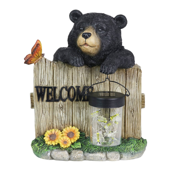 Solar Hand Painted Bear Garden Statue with a Lantern Jar of LED Bumblebees by a Welcome Fence, 9.5 by 11 Inches