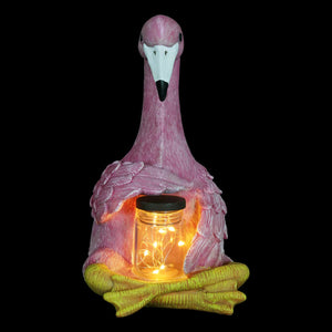 Solar Sitting Flamingo Garden Statue Holding a Glass Jar with Six LED Firefly String Lights | Shop Garden Decor by Exhart
